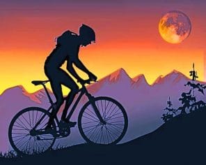 Mountain Biker On Step Hills At Sunset